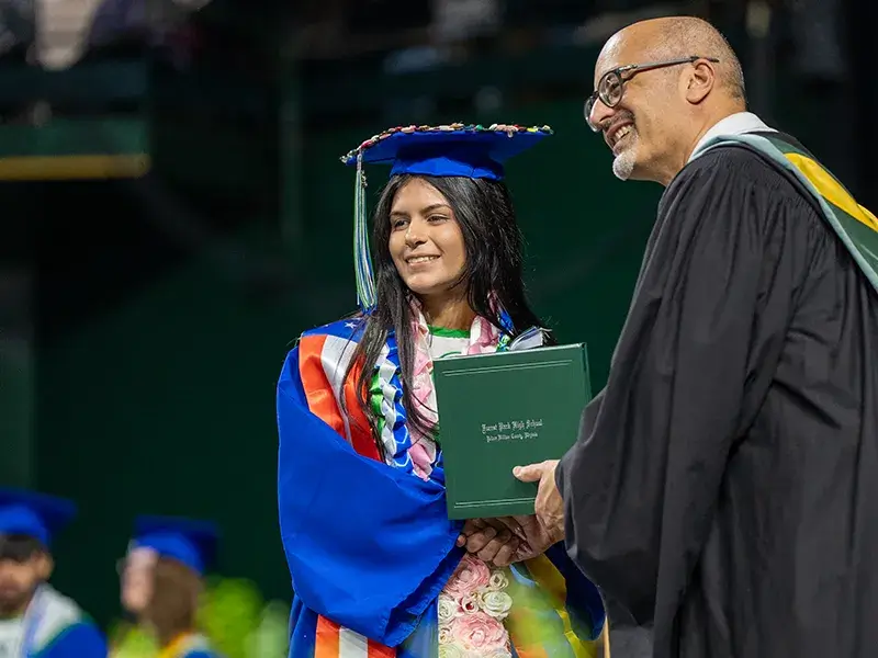Forest Park High School student receiving her diploma from Principal Martinez